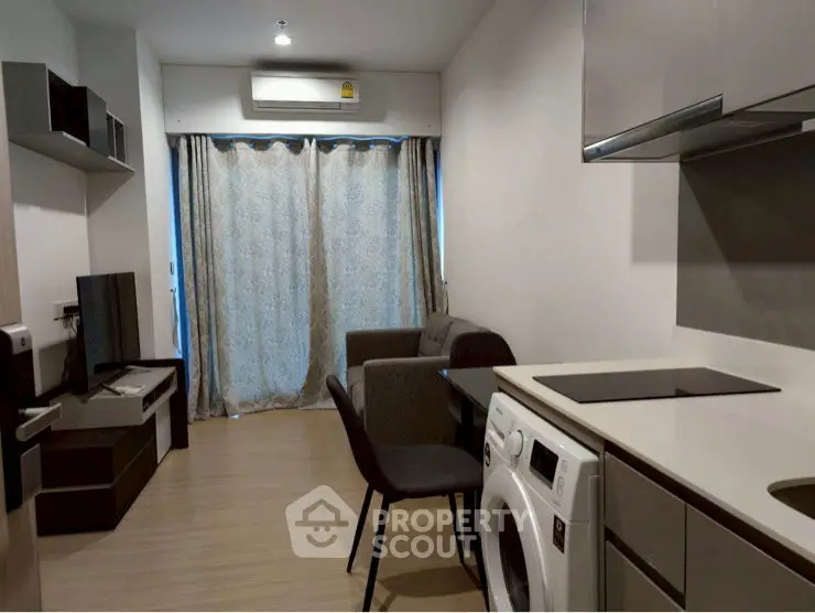 Modern compact living room with integrated kitchen and washing machine