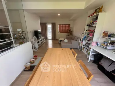 Spacious living room with modern decor and open layout, featuring a cozy seating area and dining space.