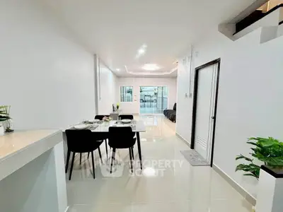 Modern open-plan living and dining area with sleek design and natural light.