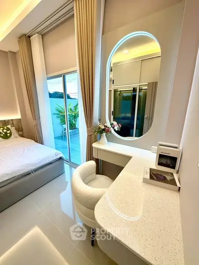 Modern bedroom with elegant vanity and balcony access
