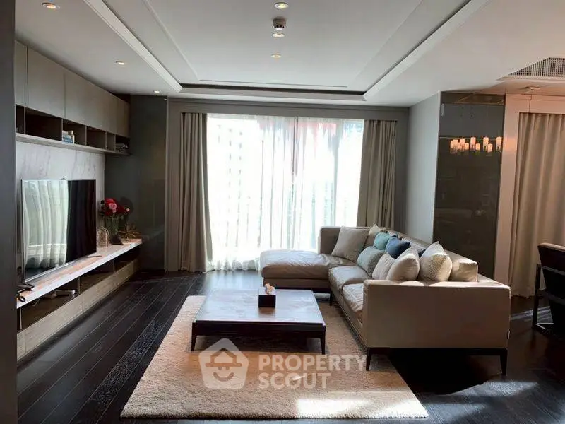 Spacious modern living room with large windows and elegant decor