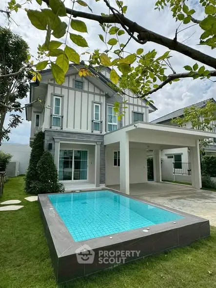 Charming two-story house with private pool and lush garden, perfect for family living.