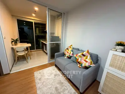 Cozy living room with modern decor and open kitchen layout