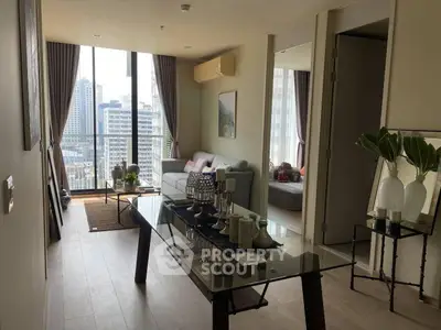 Modern living room with city view, stylish decor, and natural light.
