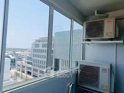 Modern balcony with air conditioning units and city view, perfect for urban living.
