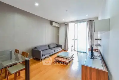Modern living room with sleek furniture and natural light in a stylish apartment.