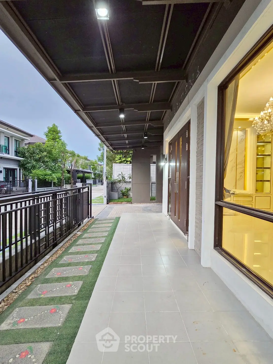 Modern house entrance with elegant pathway and large windows