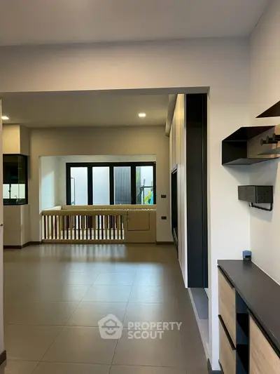 Spacious modern living room with sleek design and ample natural light.