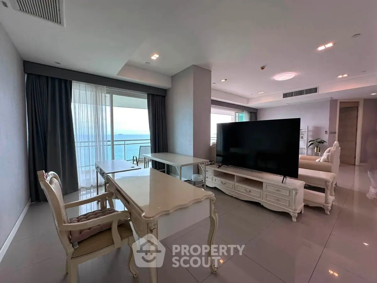 Luxurious living room with ocean view and elegant furnishings in a modern apartment.