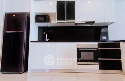 Modern kitchen with sleek white cabinets and built-in appliances
