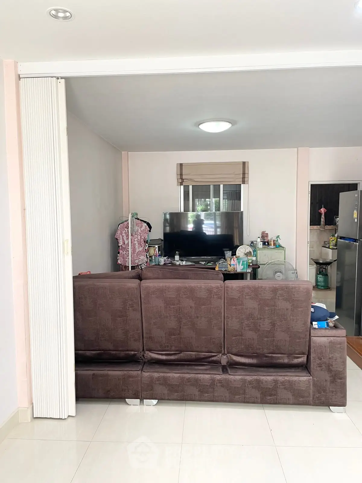 Cozy living room with modern decor and TV setup, perfect for relaxation.
