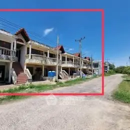 Charming row of townhouses with rustic balconies and clear blue sky, perfect for serene living.