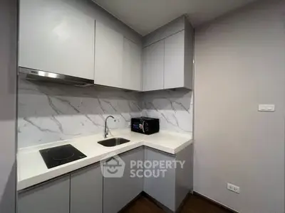 Modern kitchen with sleek cabinetry and marble backsplash
