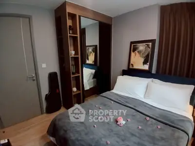 Cozy bedroom with stylish decor and mirrored wardrobe, perfect for relaxation.