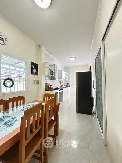 Spacious kitchen with dining area and modern appliances in a bright home