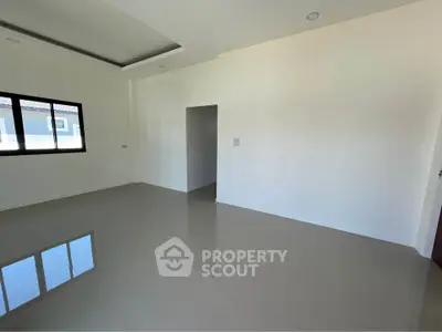 Spacious empty room with glossy tiled floor and large window