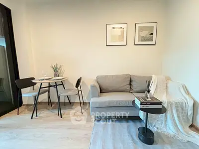 Modern living room with cozy sofa and dining area, perfect for relaxation.