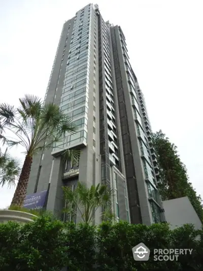 Stunning high-rise building with modern architecture and lush greenery