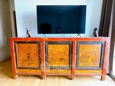 Elegant living room with vintage wooden cabinet and modern flat-screen TV