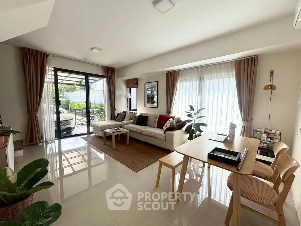 Spacious living room with modern decor and large windows offering natural light.