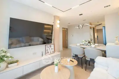 Modern living room with elegant dining area and large wall-mounted TV