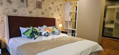 Cozy bedroom with stylish decor and comfortable bedding in modern apartment.