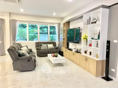 Spacious living room with modern decor and large windows