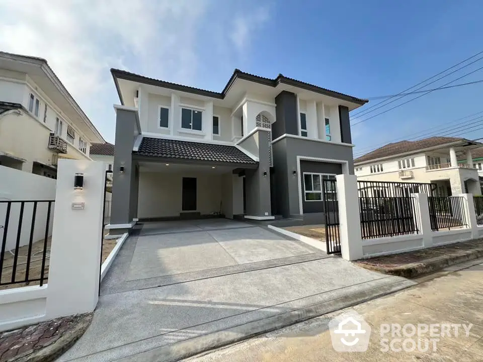 Modern two-story house with spacious driveway and elegant facade in suburban neighborhood