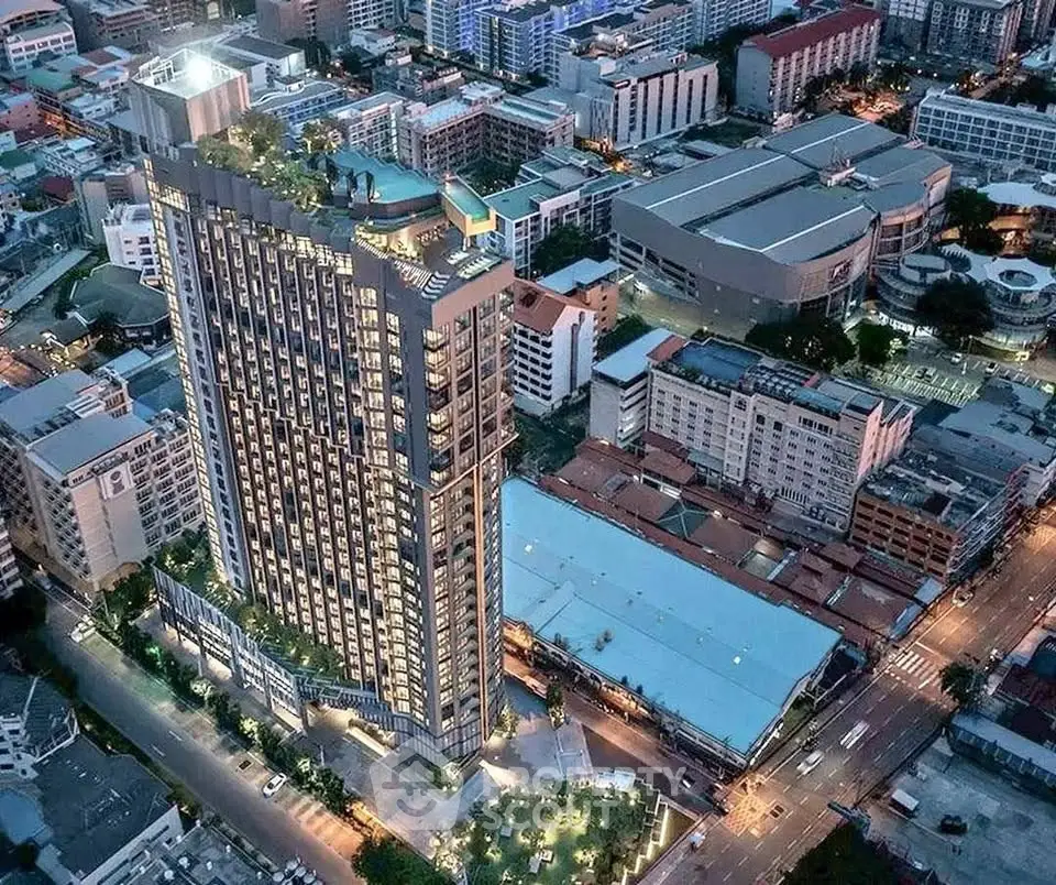 Stunning aerial view of modern high-rise building in vibrant urban setting, showcasing cityscape and architecture.