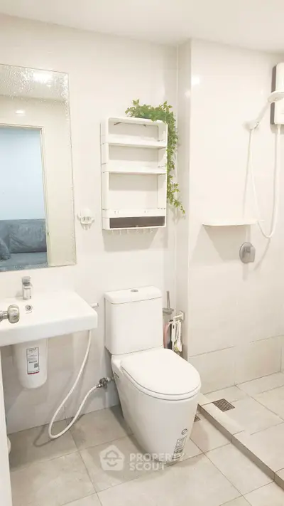 Modern bathroom with sleek fixtures and shower in a bright, minimalist design.