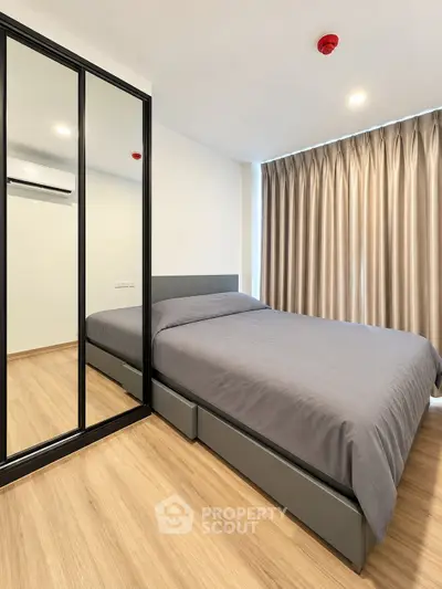 Modern bedroom with mirrored wardrobe and stylish decor