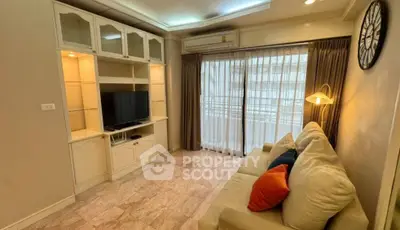 Cozy living room with modern furnishings and large window for natural light.