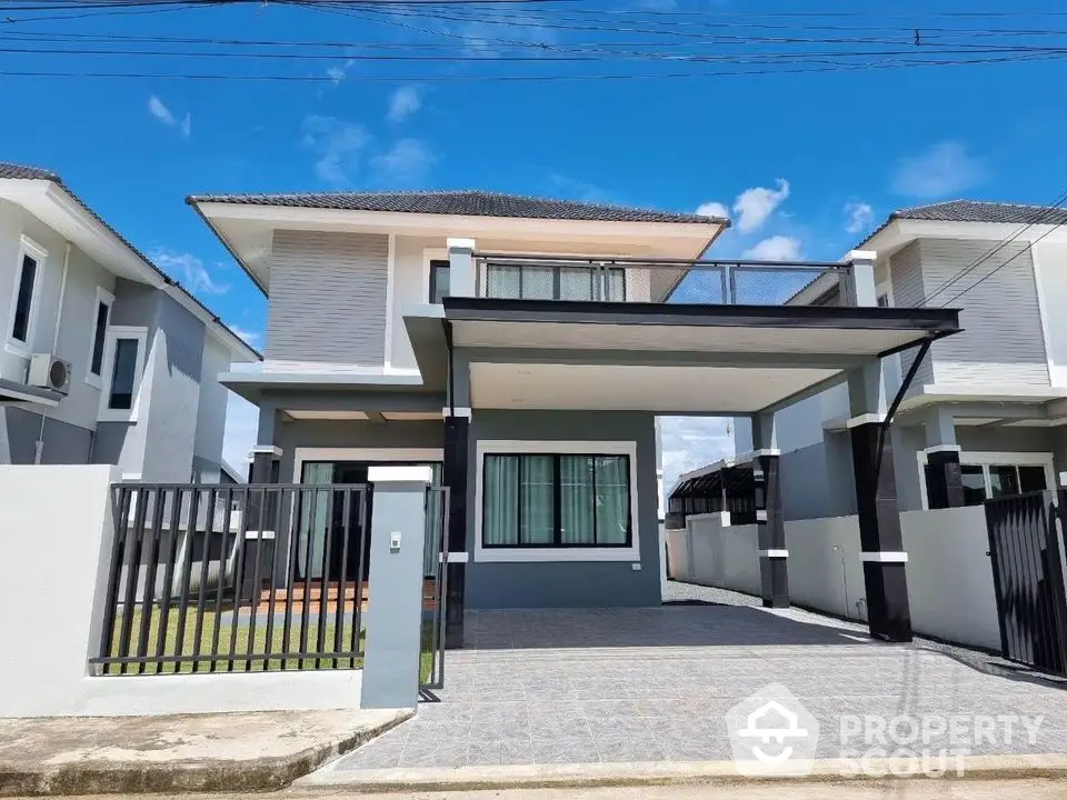 Modern two-story house with spacious driveway and sleek design in a suburban neighborhood.