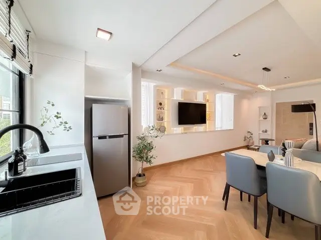 Modern open-plan living room with sleek kitchen and stylish decor