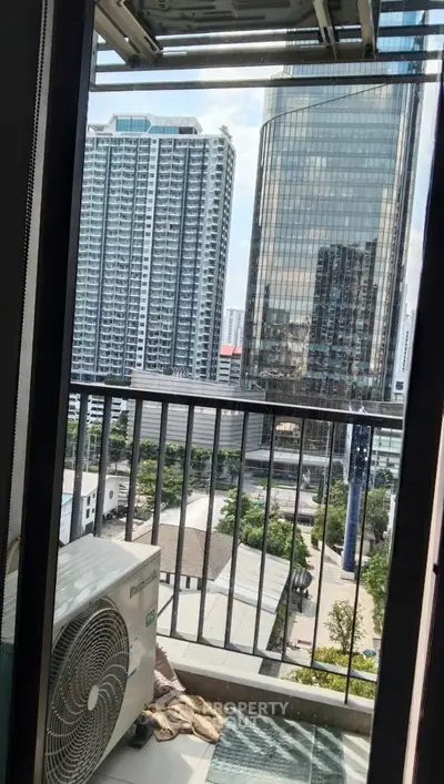 Urban balcony view with high-rise buildings and air conditioning unit.