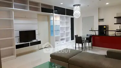 Modern living room with sleek shelves and stylish lighting in open layout apartment.