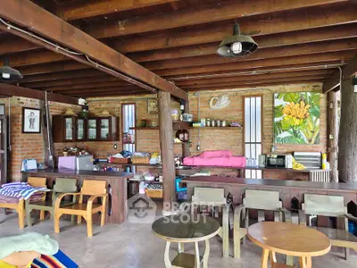 Charming rustic living room with exposed beams and eclectic decor, perfect for cozy gatherings.