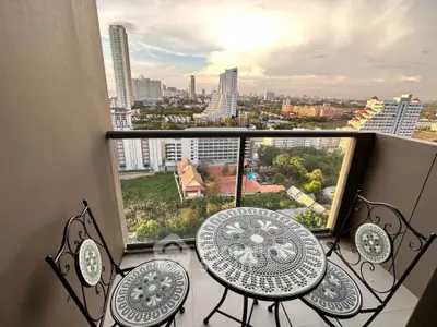 Stunning high-rise balcony with panoramic city views and elegant outdoor furniture.