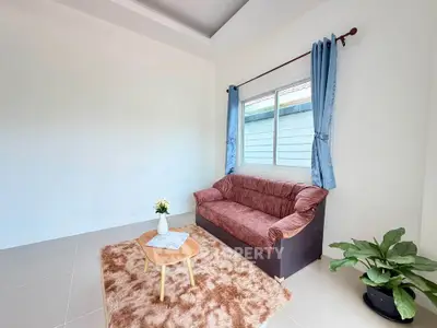 Cozy living room with plush sofa, elegant curtains, and stylish decor