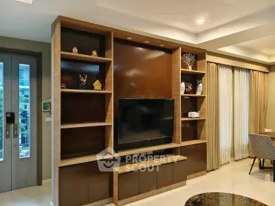 Modern living room with elegant built-in TV cabinet and stylish decor