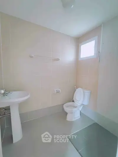 Modern bathroom with neutral tiles and natural light