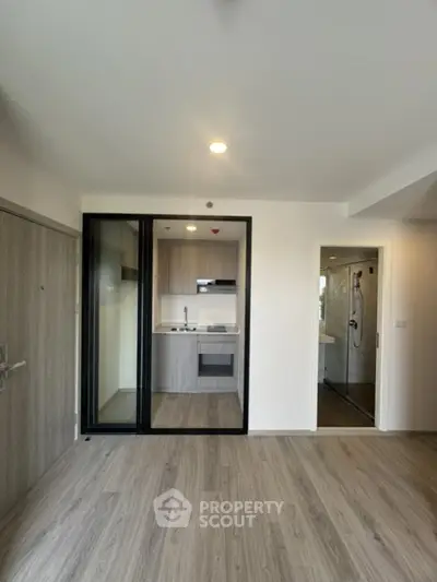 Modern apartment interior with open kitchen and wooden flooring