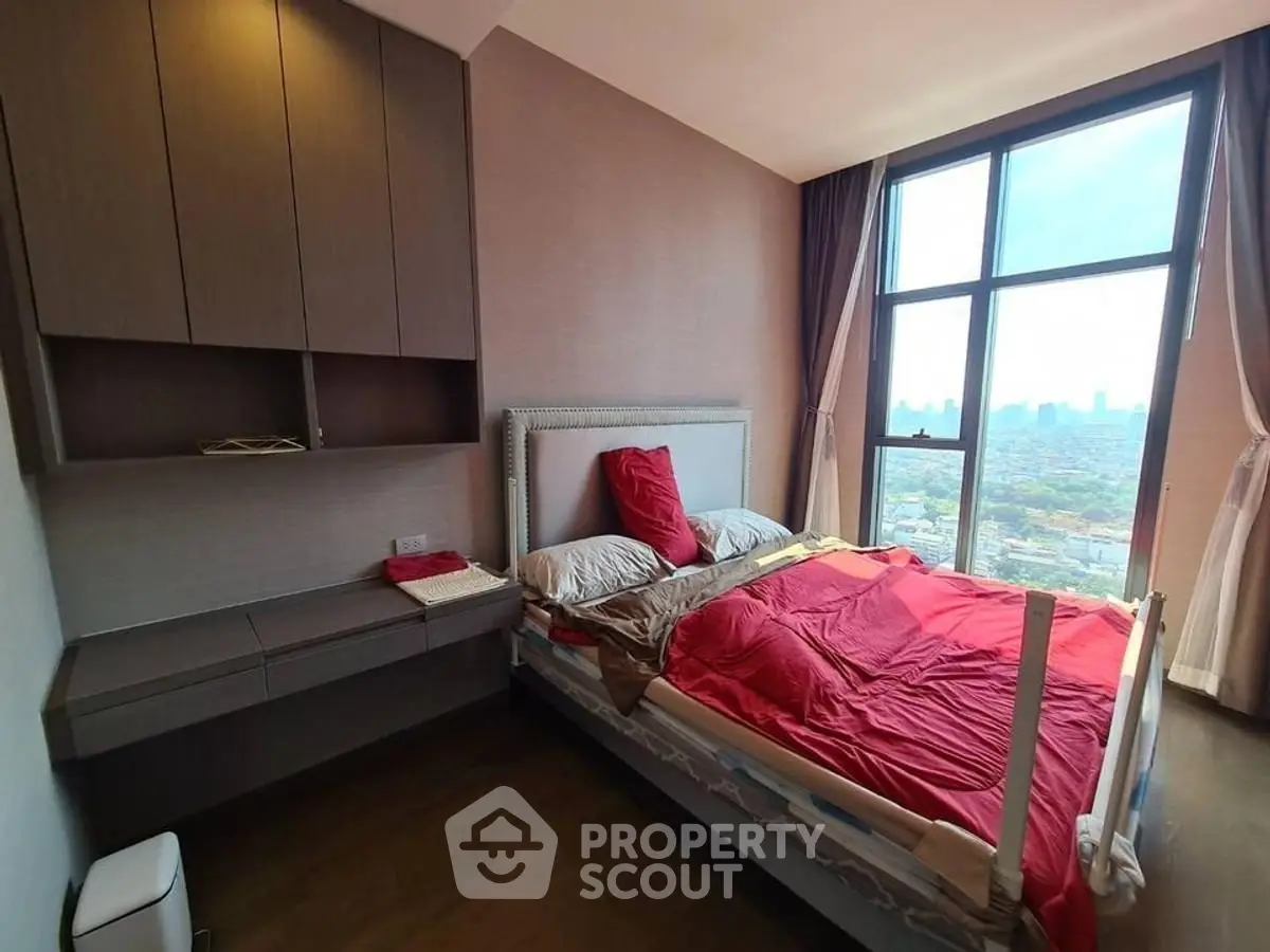 Modern bedroom with large window offering stunning city view