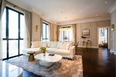 Luxurious living room with elegant decor and large windows in a modern apartment.