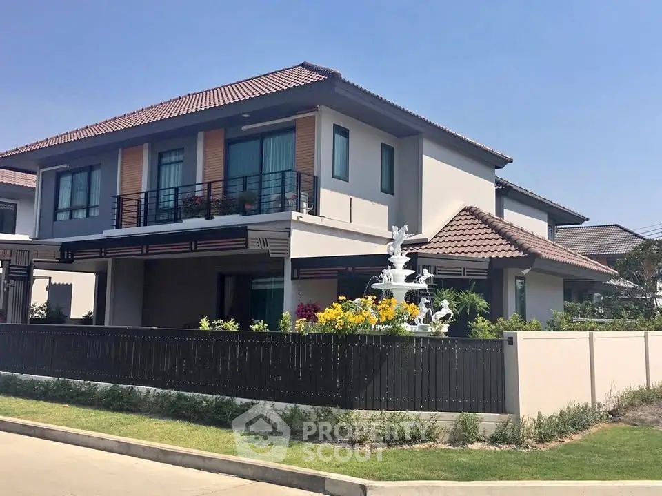 Charming two-story house with a spacious garden and elegant balcony in a serene neighborhood.