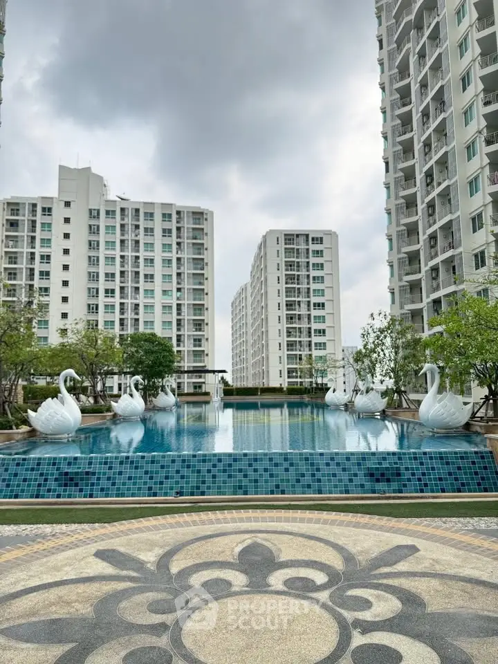 Luxurious residential complex with elegant pool and modern high-rise buildings.