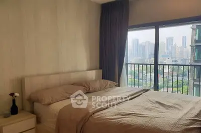 Cozy bedroom with city view and large window balcony access.