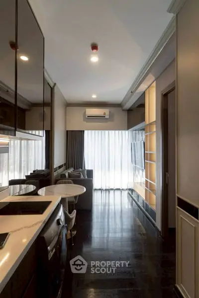 Modern apartment interior with sleek kitchen and cozy living area, featuring floor-to-ceiling windows and stylish decor.