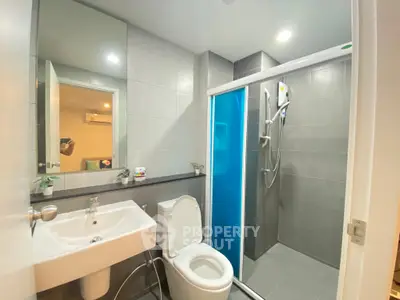 Modern bathroom with sleek shower and stylish fixtures in contemporary apartment.