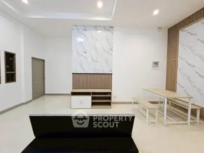 Modern living room with sleek marble accents and minimalist furniture